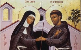 Byzantine-style icon of Saints Francis and Clare facing forward, each holding a cross, with inscriptions identifying them in Greek.