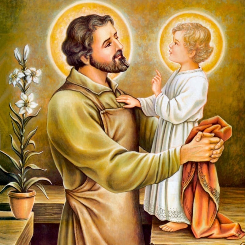 Devotional painting of Saint Joseph holding the Child Jesus, with white lilies beside them, both with golden haloes.
