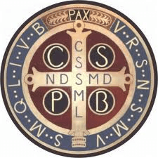 Reverse of the Saint Benedict Medal showing the Vade Retro Satana cross with inscribed Latin initials around the rim.