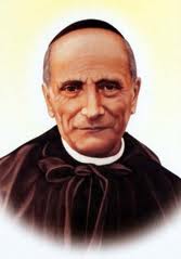 Portrait photograph of Saint Annibale Maria Di Francia in black clerical dress with white collar, facing forward.